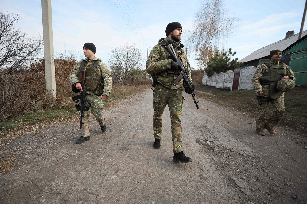 Ukrainian servicemen patrol in the streets of the Katerynivka village, in the Lugansk region on November 2, 2019, after their withdrawal. u00e2u20acu2022 AFP pic  