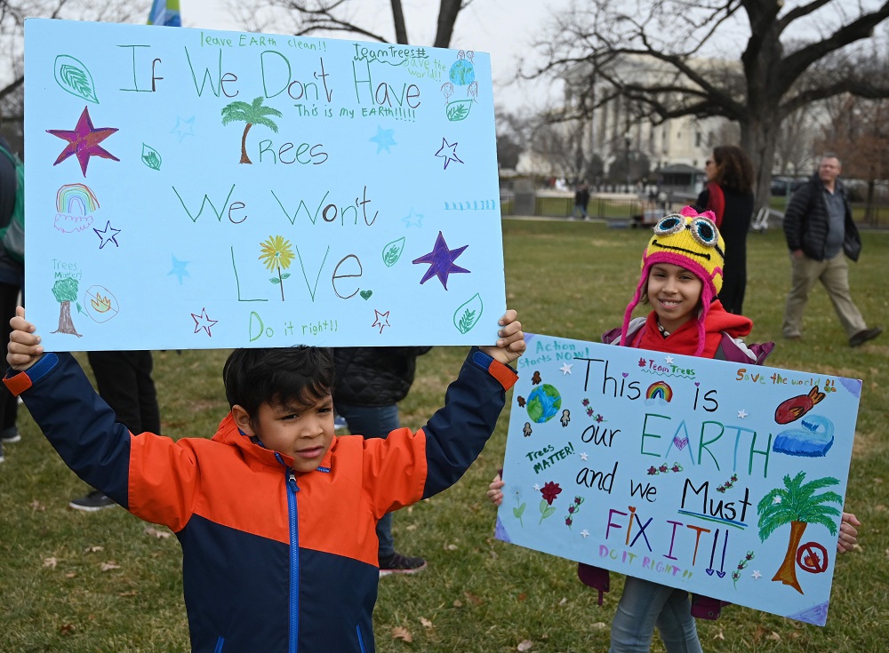 Children display posters in front of the US Capitol as actresses and activists Lily Tomlin and Jane Fonda (out of frame) lead a climate protest in Washington December 27, 2019. u00e2u20acu201d AFP pic 