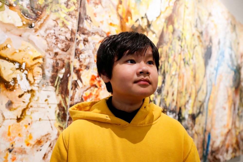 Xeo Chu, a Vietnamese art prodigy, poses in front of one of his pieces before his debut solo exhibition at the Georges Berges Gallery in New York City, New York December 18, 2019. u00e2u20acu2022 Reuters pic