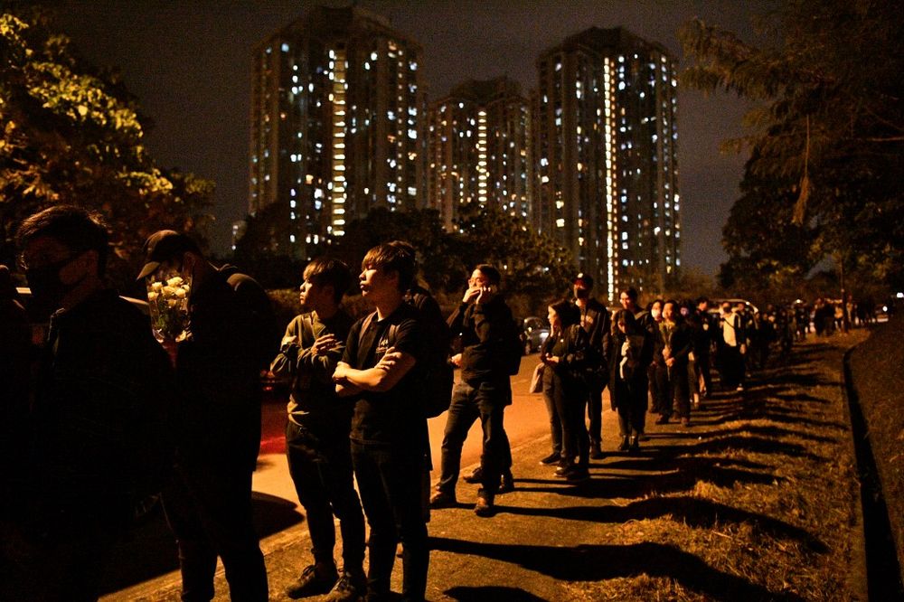 Mourners arrive to pay their respects at a memorial service on at Po Fook Hill Cemetery in Shatin in Hong Kong December 12, 2019, for Alex Chow who died from head injuries sustained during a fall inside a multi-storey carpark where police and protesters w