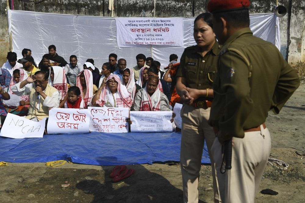 Police stand next to protestors taking part in a demonstration against the Indian governmentu00e2u20acu2122s Citizen Amendement Bill (CAB) in Guwahati on December 14, 2019. u00e2u20acu201d AFP pic