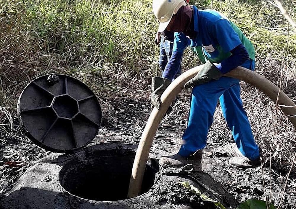 A worker doing the cleaning work at a manhole near the Bandar Bukit Mahkota IWK plant in Bangi December 23, 2019. u00e2u20acu201d Picture courtesy of SPAN