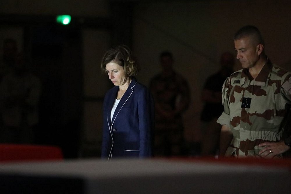 French Defence Minister Florence Parly (right) and French general Thierry Burkhard in front of the coffins of the 13 French soldiers killed in a helicopter collision in Mali November 27, 2019 u00e2u20acu201d Sirpa handout via AFP