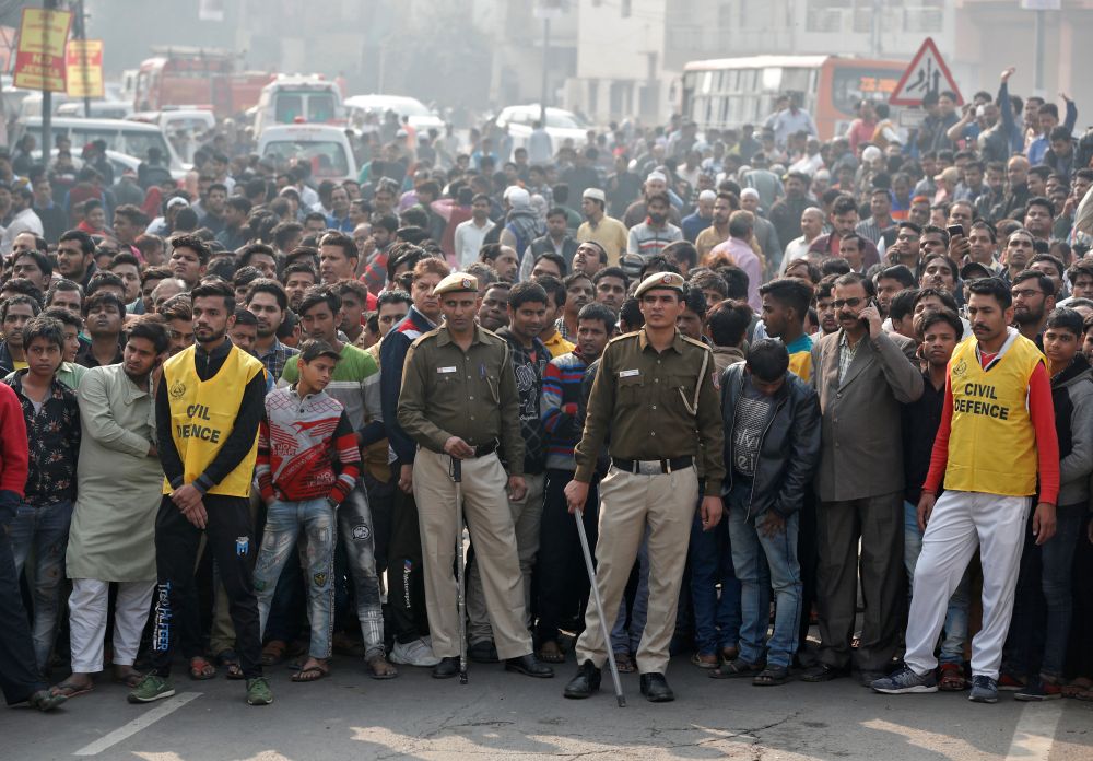 Police stand guard as onlookers gather near the site of a fire that swept through a factory where labourers were sleeping, in New Delhi December 8, 2019. u00e2u20acu201d Reuters pic