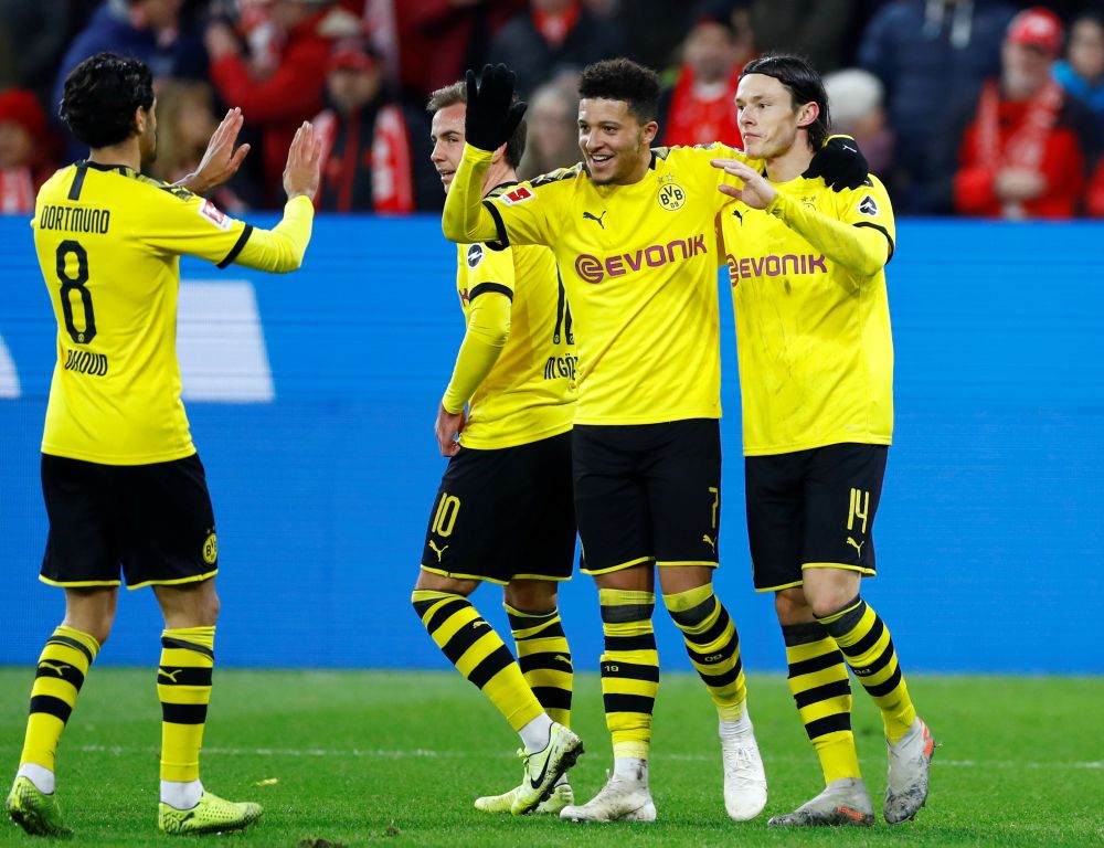 Borussia Dortmund's Nico Schulz (right) celebrates scoring their fourth goal against Mainz 05 with teammates at the Opel Arena in Mainz December 14, 2019. u00e2u20acu201d Reuters pic