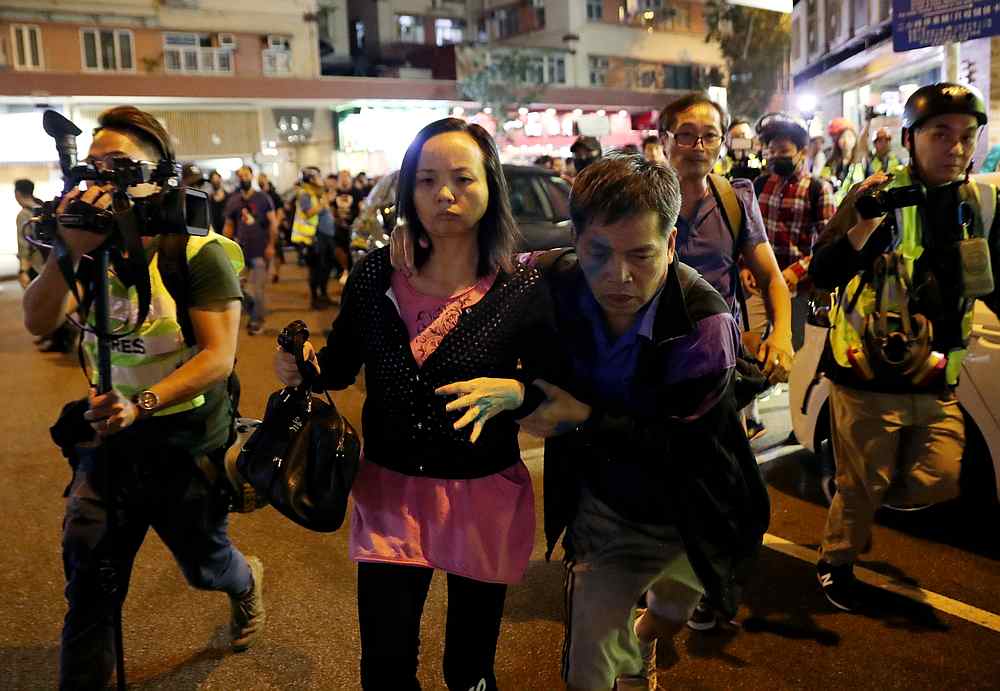 Bystanders who were cornered by a group of protesters run away after a day of protests in Hong Kong December 1, 2019. u00e2u20acu201d Reuters pic