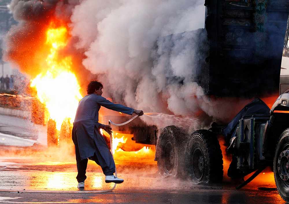 A man attempts to extinguish a burning truck hit by a magnetic bomb in Jalalabad, Afghanistan November 23, 2019. Five Afghans were killed in a new attack in the city December 4, 2019. u00e2u20acu201d Reuters pic