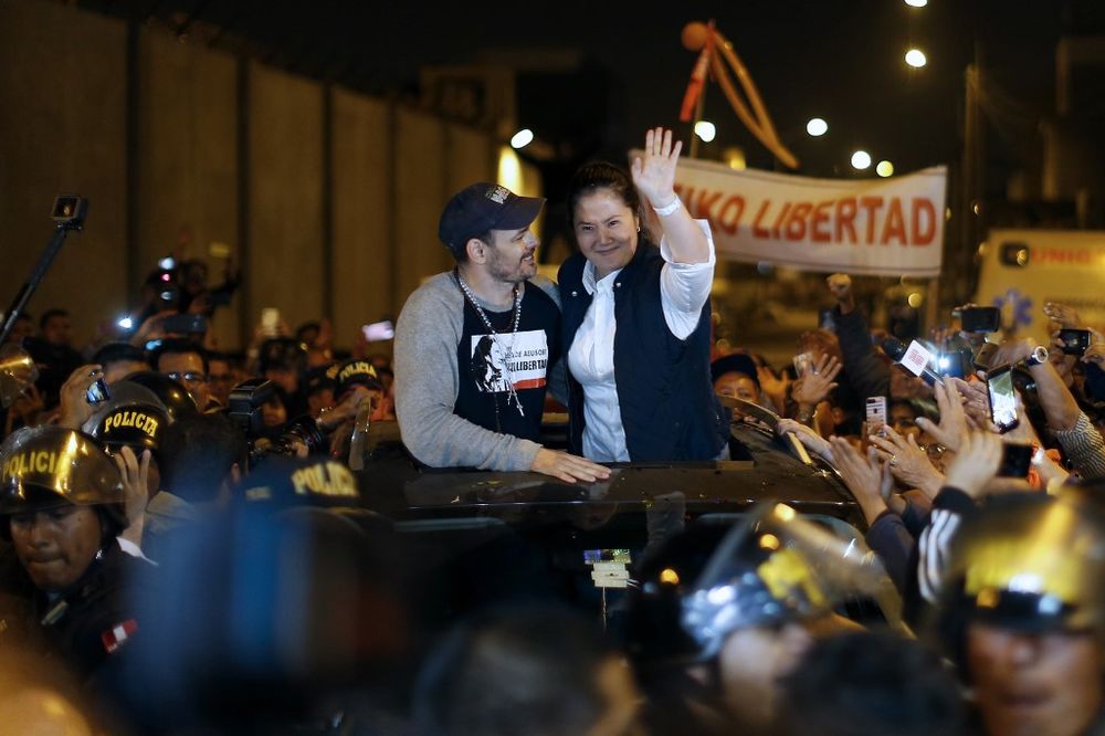 Peruvian politician Keiko Fujimori (right) waves to supporters next to her husband Mark Villanella as she is released from prison in Lima on November 29, 2019. u00e2u20acu201d AFP pic