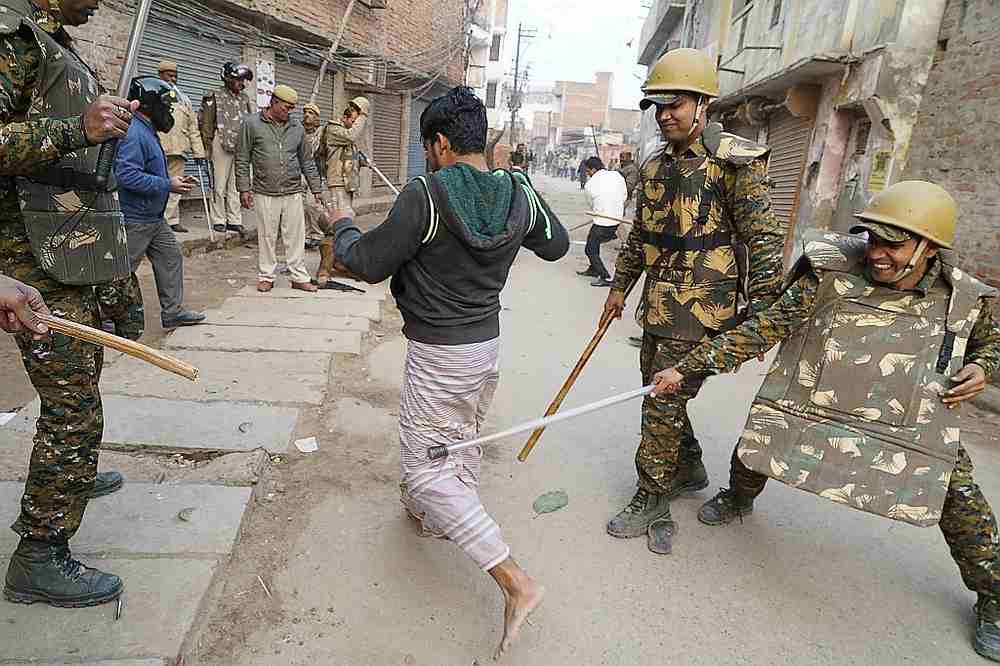 Policemen with sticks locally known as 'lathi' beat a protester during a demonstration against India's new citizenship law in Varanasi December 20, 2019. u00e2u20acu201d AFP pic