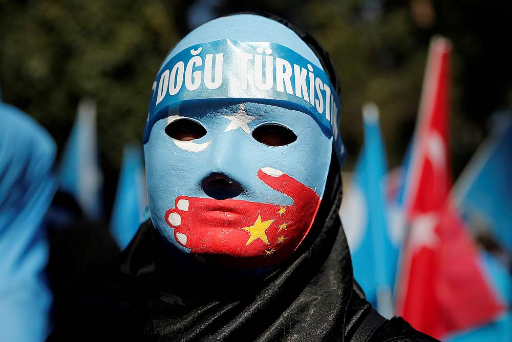 An ethnic Uighur demonstrator wears a mask as she attends a protest against China in front of the Chinese Consulate in Istanbul, Turkey October 1, 2019. u00e2u20acu201d Reuters pic
