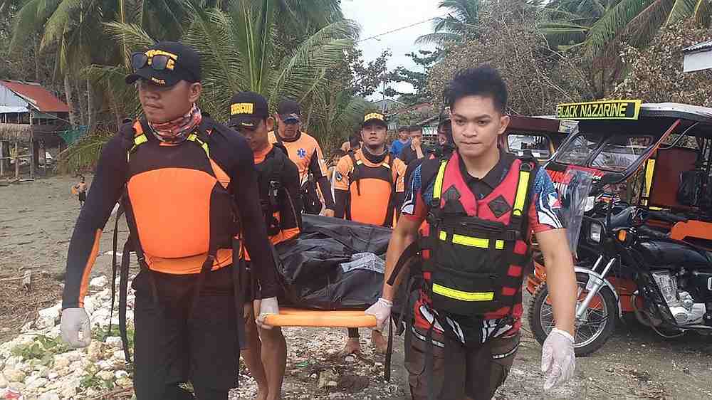 Rescuers carry a body, believed to be one of several fishermen who went missing at the height of Typhoon Phanfone that pummelled the central Philippines December 27, 2019. u00e2u20acu201d AFP pic