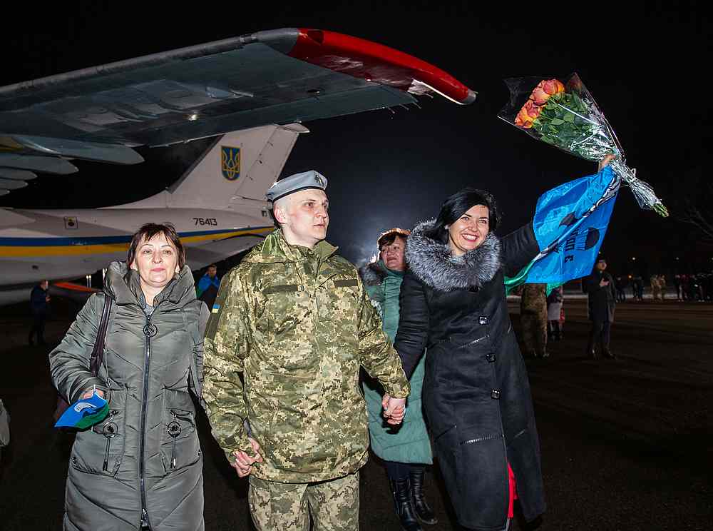 A Ukrainian serviceman prisoner is welcomed by relatives at the airport outside Kiev, Ukraine December 29, 2019. u00e2u20acu201d Ukrainian Presidential Press Service handout via Reuters
