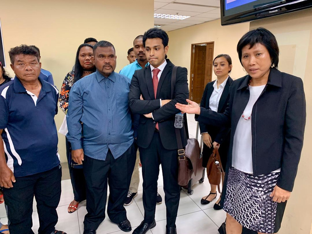 Lawyer Tan Poh Lai (far right) with representatives of the Orang Seletar at the Johor Baru Civil High Court at Menara Cyberport in Johor Baru today. u00e2u20acu201d Picture by Ben Tan