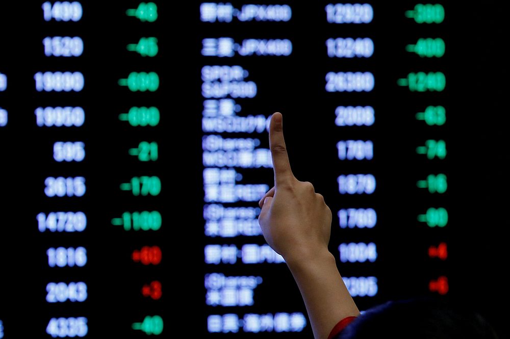 A woman points to an electronic board showing stock prices at the Tokyo Stock Exchange, Japan January 4, 2019. u00e2u20acu201d Reuters pic