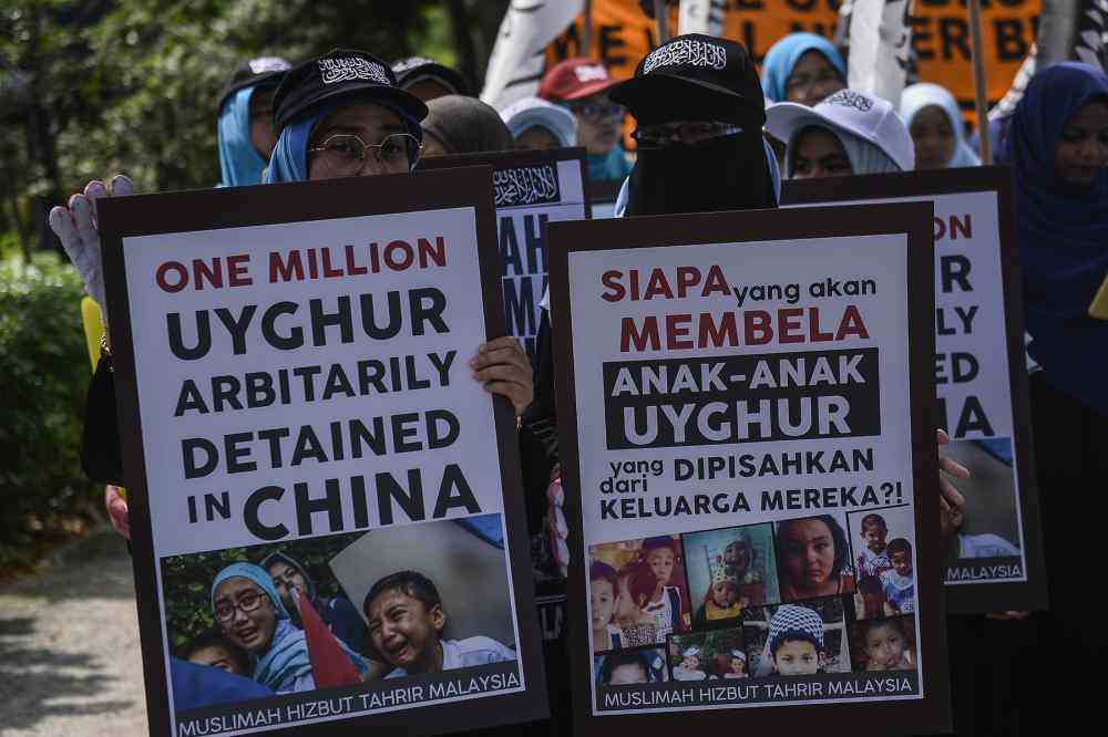 Hizbut Tahrir protesters carry placards during a protest held in solidarity with the Uighur community in China, December 27, 2019. ― Picture by Miera Zulyana