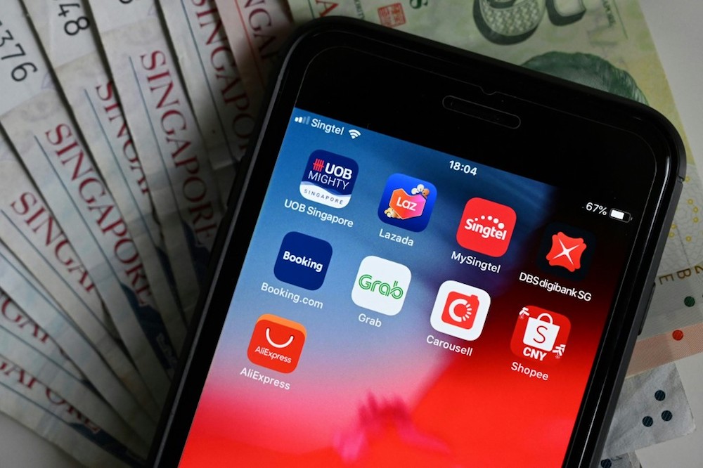 This illustration photograph taken on January 9, 2020 shows banking and purchasing apps on a smartphone in Singapore. u00e2u20acu201d AFP pic