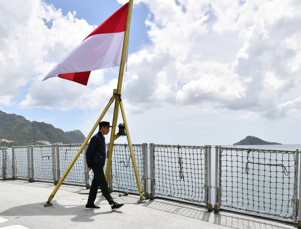 Indonesia Presidents Joko Widodo walks next to a national flag during his visit at a military base in Natuna, near South China Sea, Indonesia January 8, 2020. u00e2u20acu201d Indonesian Presidential Palace handout via Reuters