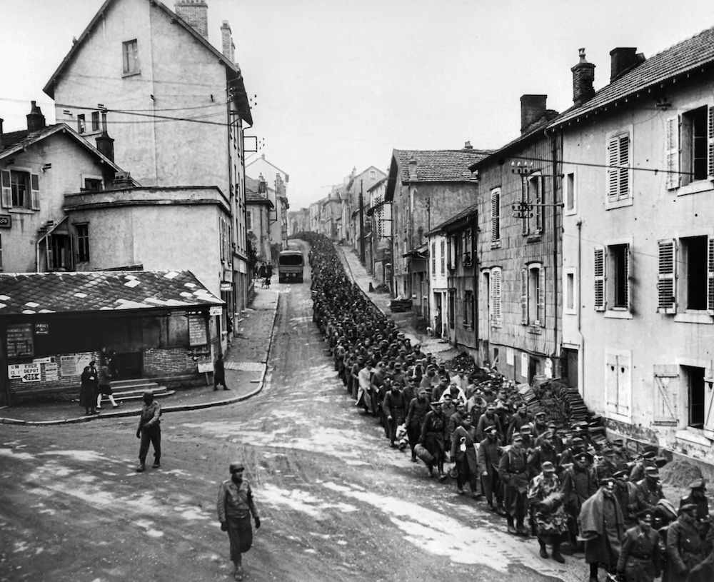 German prisoners captured in Strasbourg cross Epinal under escort in December 1944. u00e2u20acu201d AFP pic