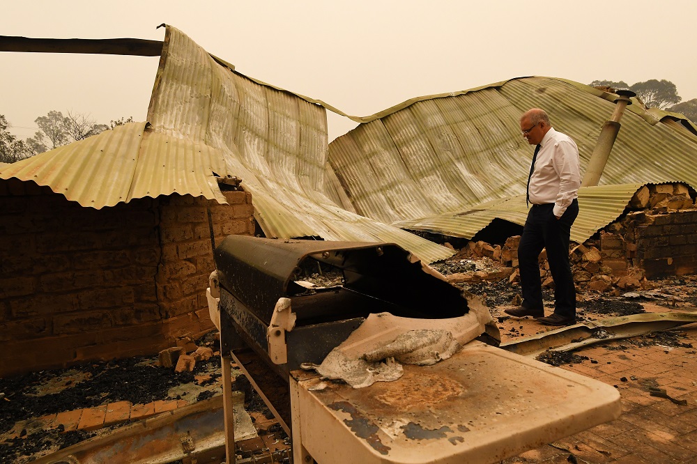 Australiau00e2u20acu2122s Prime Minister Scott Morrison tours the fire-devastated Wildflower farm owned by Paul and Melissa Churchman in Sarsfield, Victoria January 3, 2020. u00e2u20acu201d AAP Image/James Ross/via Reuters 