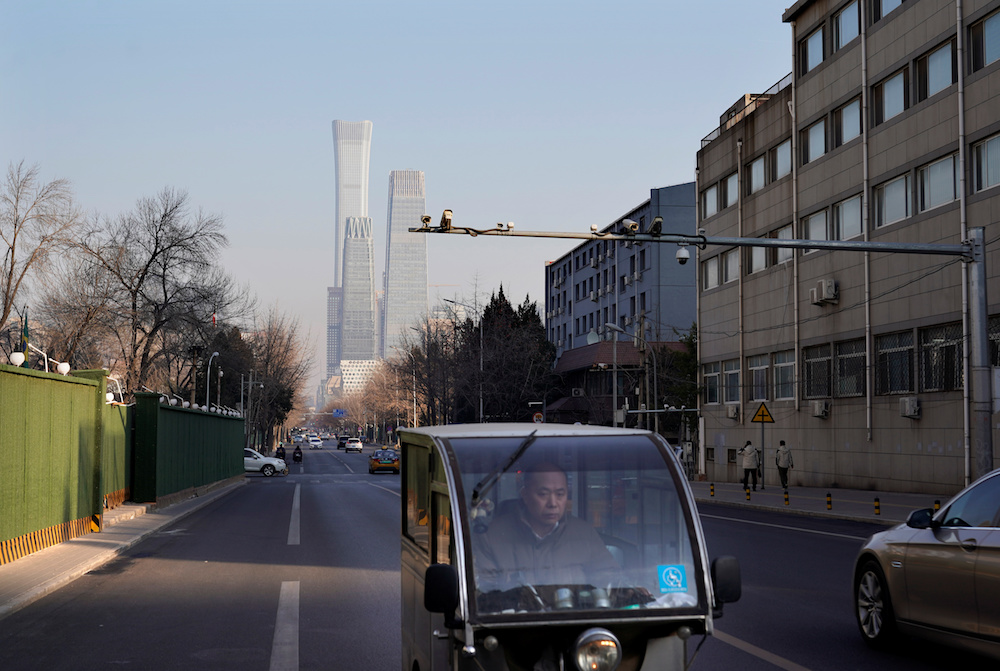 A man rides a motor tricycle past the buildings of Beijingu00e2u20acu2122s central business area January 3, 2020. u00e2u20acu201d Reuters pic