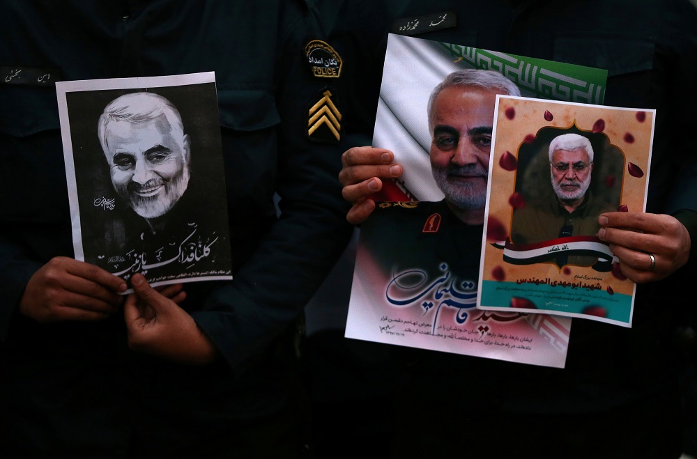 Iranian guards hold a picture of the late Iranian Major-General Qassem Soleimani, during a protest against the assassination of Soleimani, in front of United Nation office in Tehran January 3, 2020. u00e2u20acu201d Picture by WANA/Nazanin Tabatabaee via Reuters