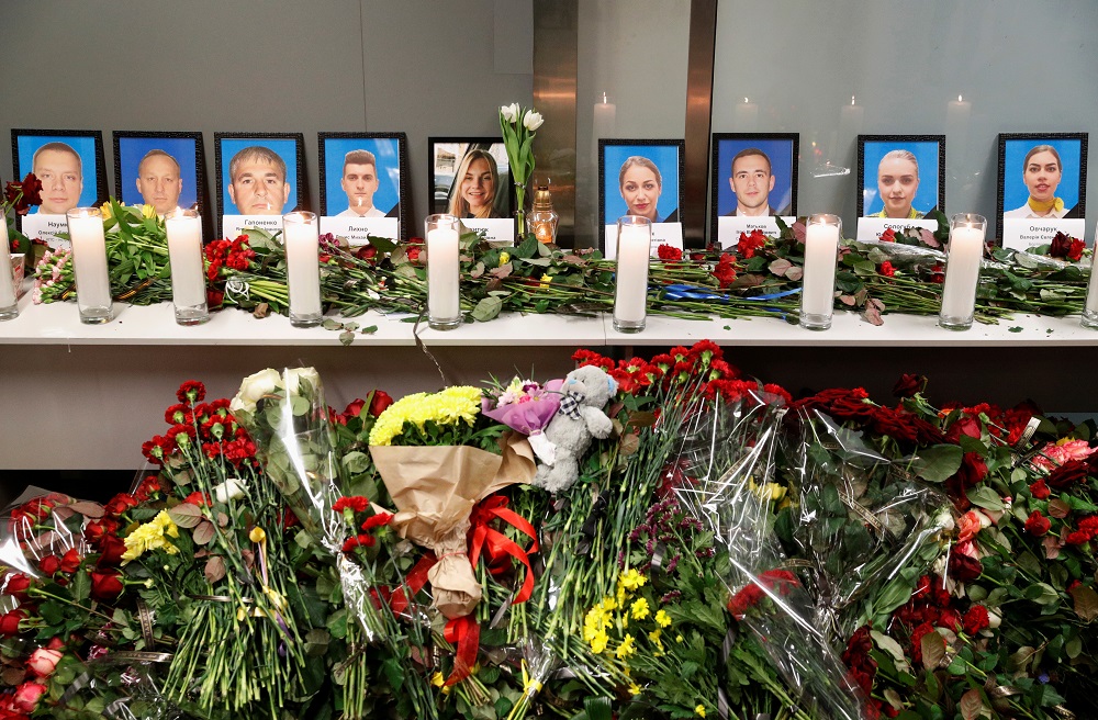 Flowers and candles are placed in front of the portraits of the flight crew members of the Ukraine International Airlines Boeing 737-800 plane that crashed in Iran, at a memorial at the Boryspil International airport outside Kiev January 8, 2020. — Reuters pic