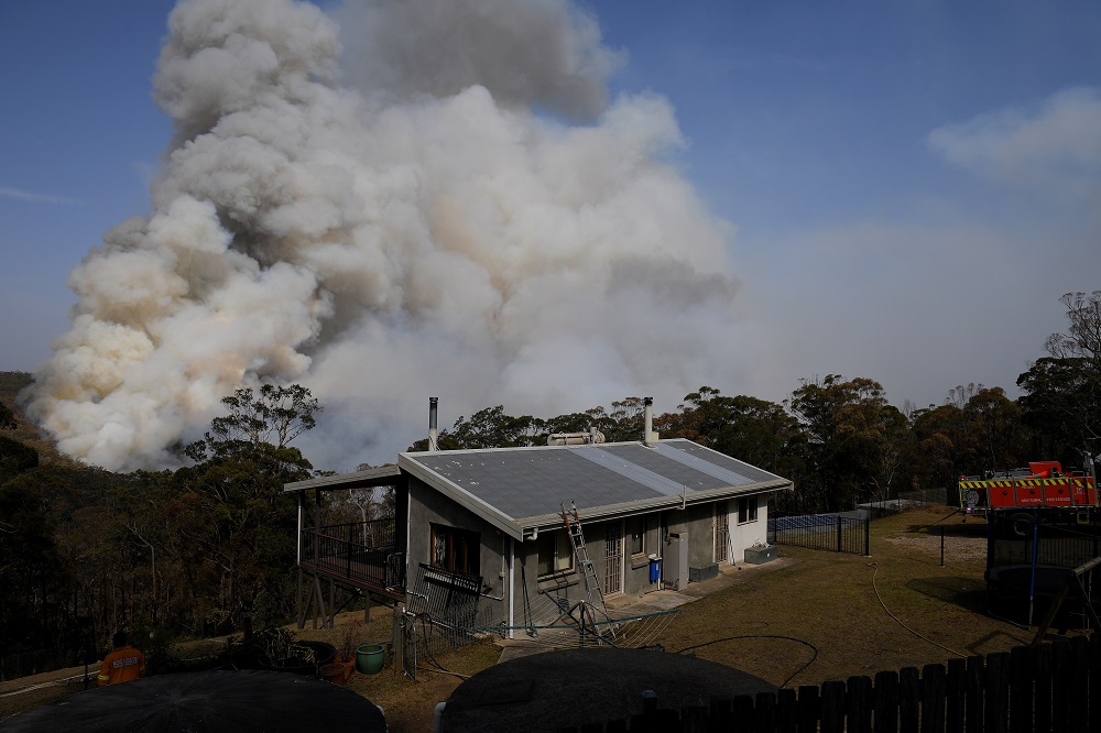 NSW Rural Fire Service crews watch on as a fire burns in bushland close to homes at Penrose in the NSW Southern Highlands, south of Sydney January 10, 2020. u00e2u20acu201d TAAP Image/Dan Himbrechts/via Reuters