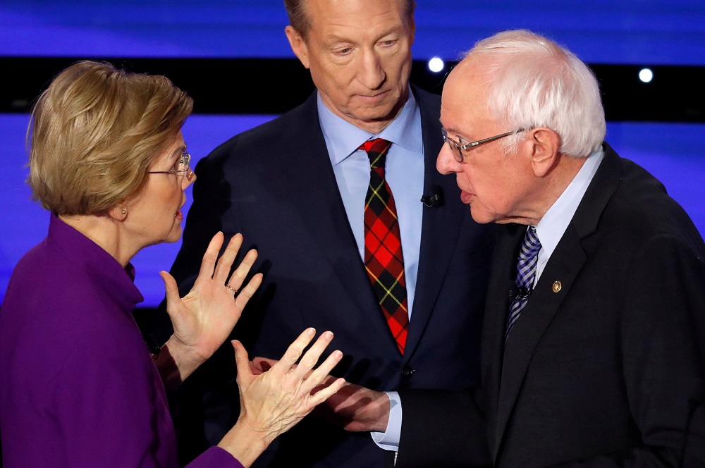 Democratic 2020 US presidential candidates (left) Senator Elizabeth Warren speaks with Senator Bernie Sanders as billionaire activist Tom Steyer listens at Drake University in Des Moines, Iowa January 14, 2020. u00e2u20acu201d Reuters pic