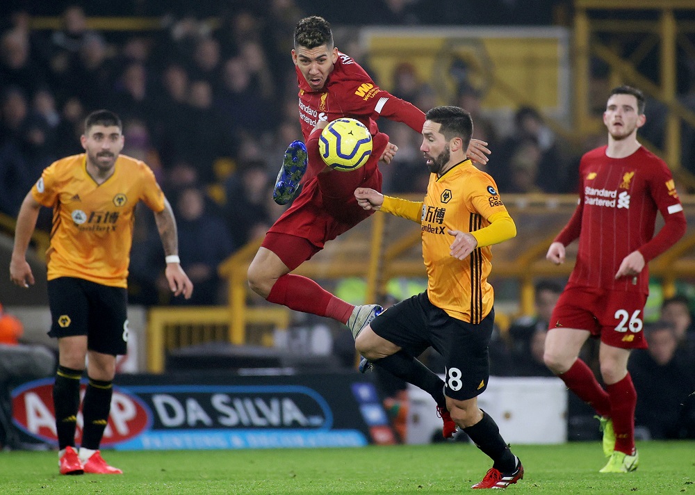 Liverpool's Roberto Firmino in action with Wolverhampton Wanderers' Joao Moutinho at the Molineux Stadium in Wolverhampton January 23, 2020. u00e2u20acu201d Action Images via Reuters