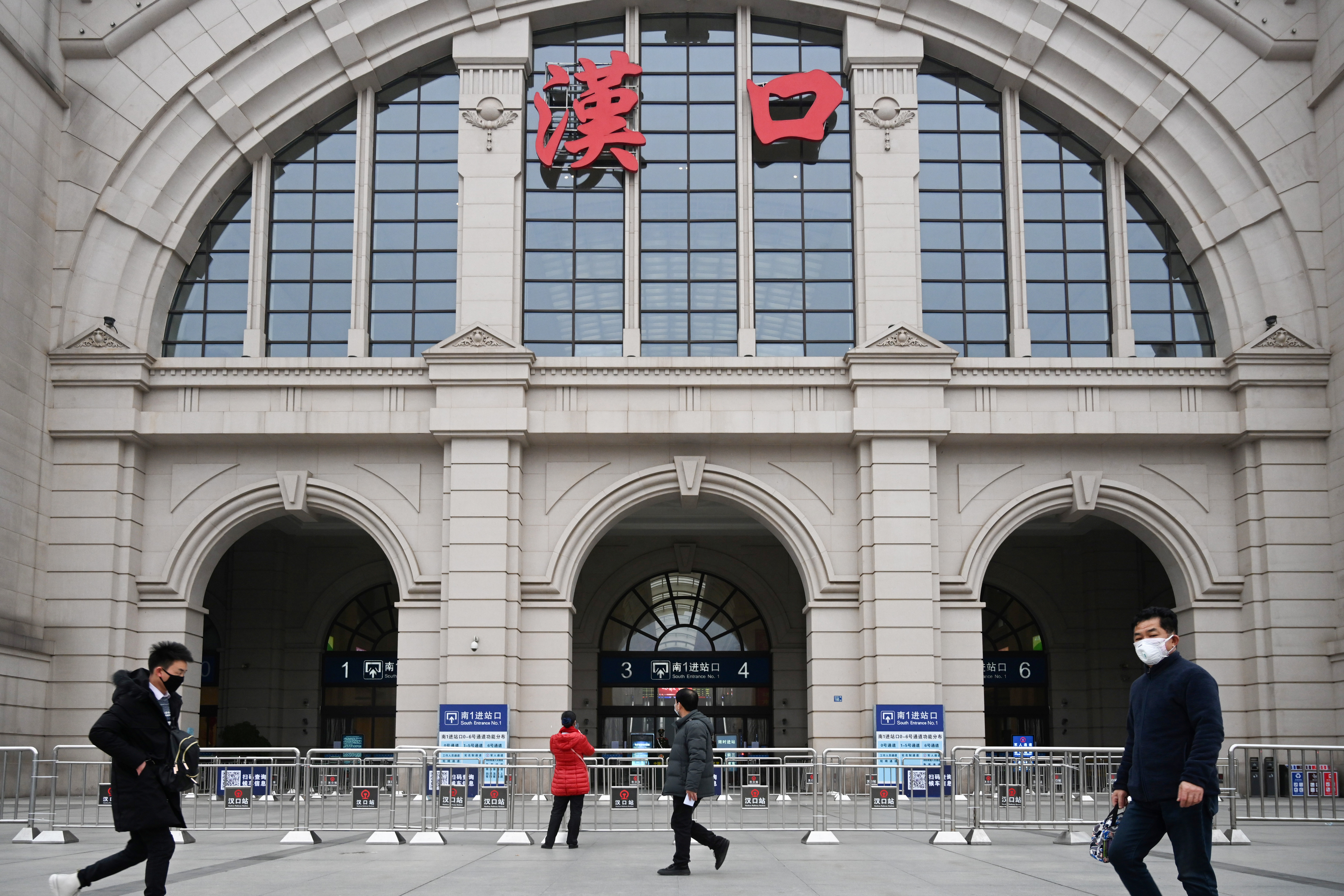People walk past the closed Hankou Railway Station after the city was locked down following the outbreak of a new coronavirus in Wuhan January 23, 2020. u00e2u20acu201d China Daily via Reuters