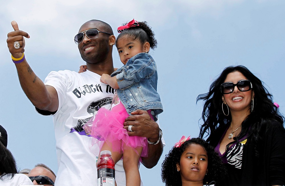 File photo of Los Angeles Lakers star Kobe Bryant carrying his daughter Gianna, as Vanessa and daughter Natalia (second right) stand next to him during the NBA Championship parade in Los Angeles June 21, 2010. — Reuters pic