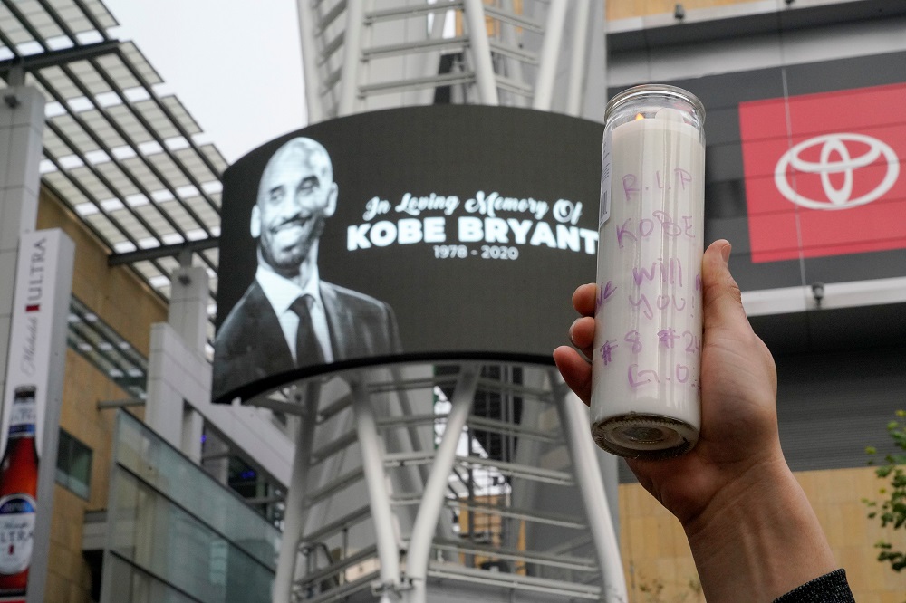 A mourner holds up a lit candle in Microsoft Square near the Staples Centre to pay respects to Kobe Bryant after a helicopter crash killed the retired basketball star, in Los Angeles January 26, 2020. u00e2u20acu201d Reuters pic