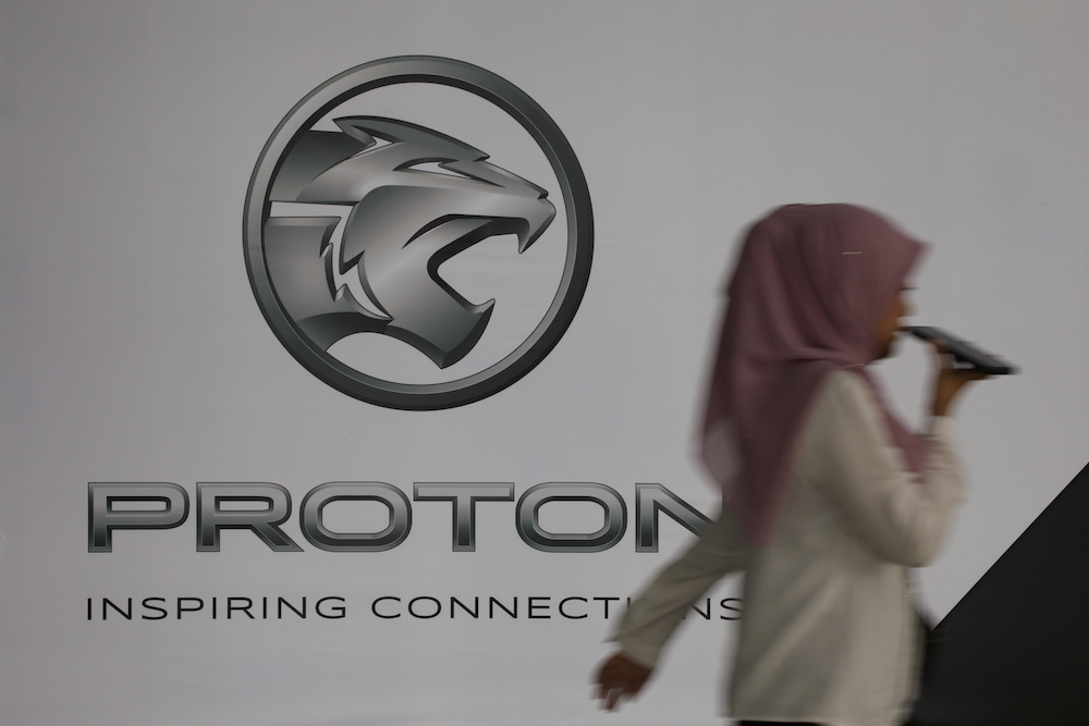 A woman walks past a logo of Proton at its headquarters in Subang Jaya January 20, 2020. u00e2u20acu201d Reuters pic