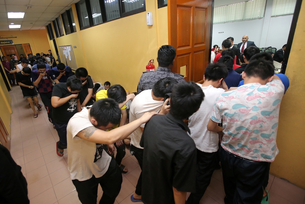 Some of the 131 Chinese nationals, including eight women, who were arrested in an immigration bust are seen at the Sessions Court in Teluk Intan January 2, 2020. — Picture by Farhan Najib
