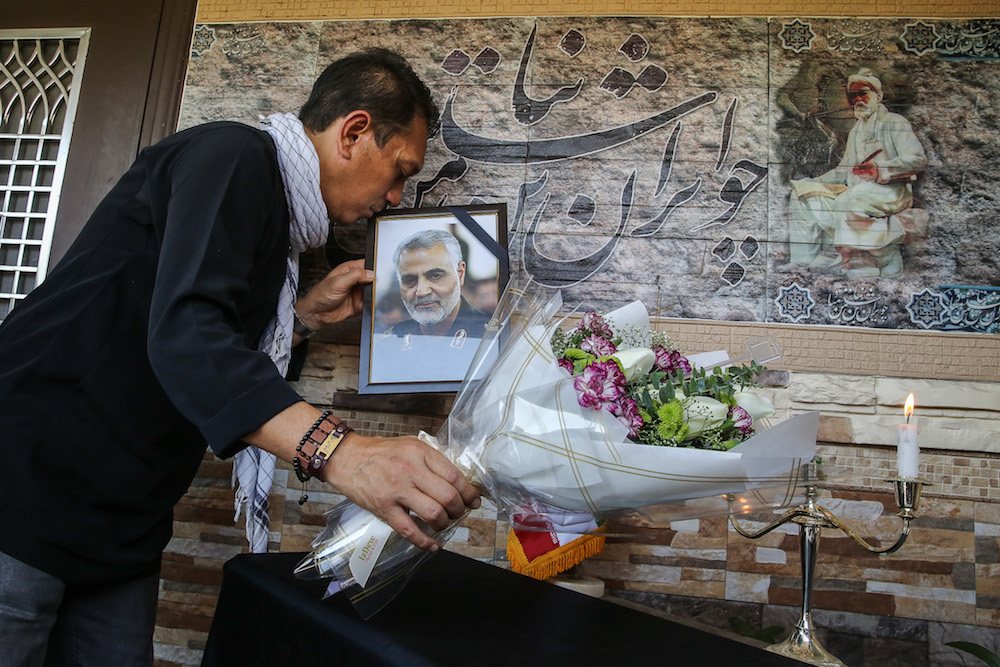 A man kisses a picture of assassinated Iranian general Qasem Soleimani at the Iranian Embassy in Kuala Lumpur January 7, 2020. ― Picture by Yusof Mat Isa
