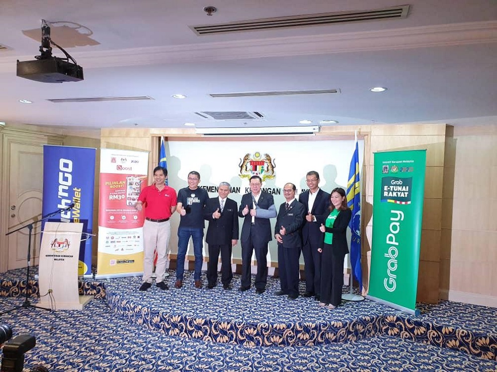 Finance Minister Lim Guan Eng and Khazanah deputy managing director Tengku Datuk Seri Azmil Zahruddin Raja Abdul Aziz (2nd right) take a group photo during the launch of e-Tunai Rakyat in Putrajaya January 14, 2020. u00e2u20acu201d Picture courtesy of Touch u00e2u20acu02dcn Go e