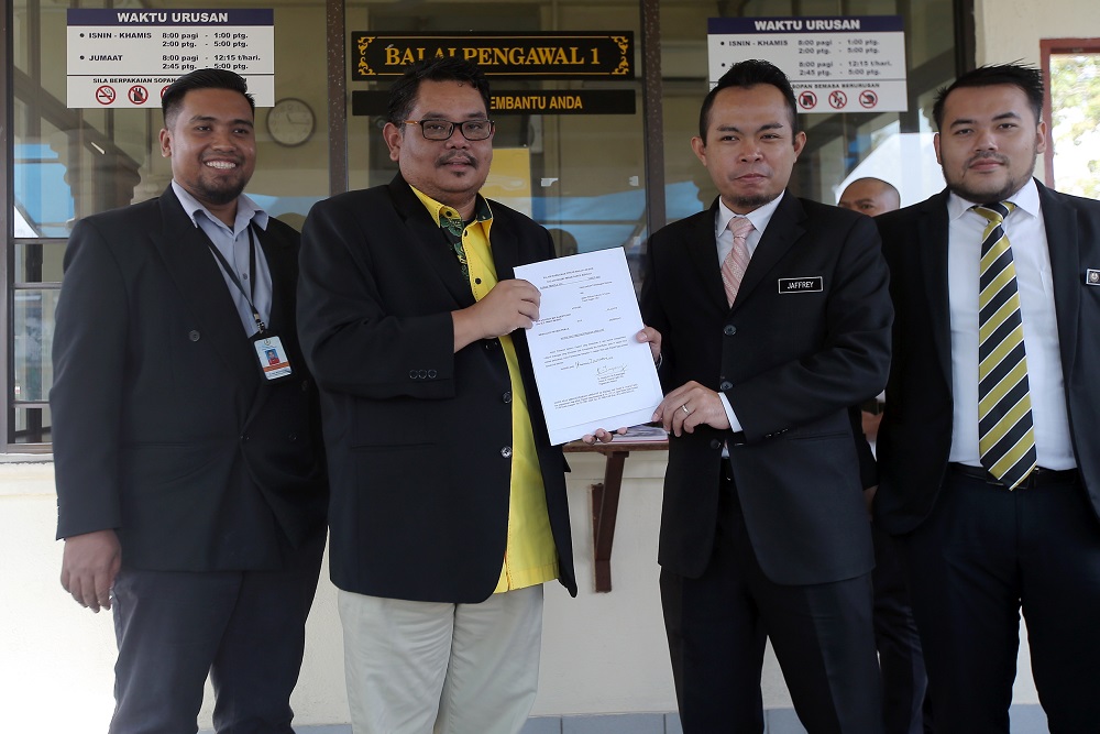 Aswannudin Hariffudin (second left) and Perak mentri besaru00e2u20acu2122s special officer Mohd Jaffery Mohd Zainol in front of the State Secretariat Building in Ipoh January 15, 2020. u00e2u20acu201d Picture by Farhan Najib