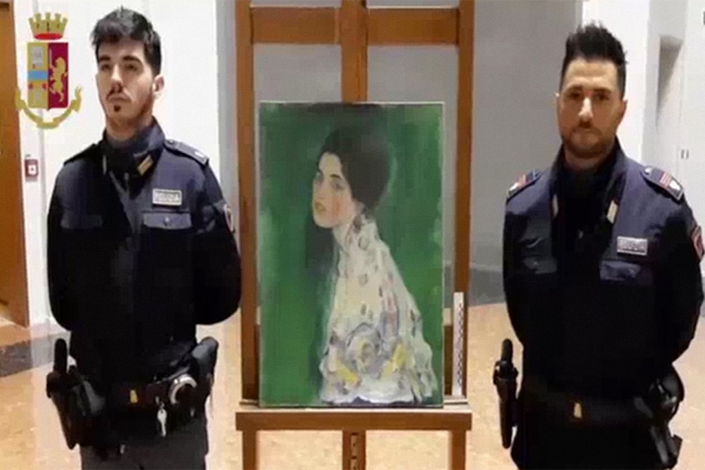 Police officers standing by a painting stolen over 20 years ago, found to be painted by Austrian painter Gustav Klimt, found by chance in the gardens of a museum in Piacenza, northern Italy Dec 11, 2019. u00e2u20acu201d Italian State Police pic via AFP 
