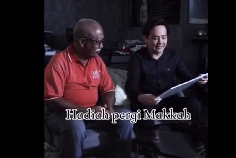 Calvin Khiu presenting Shohor with the award that he received which is the all-expenses paid trip to Makkah. u00e2u20acu201d Screengrab from Tik Tok 