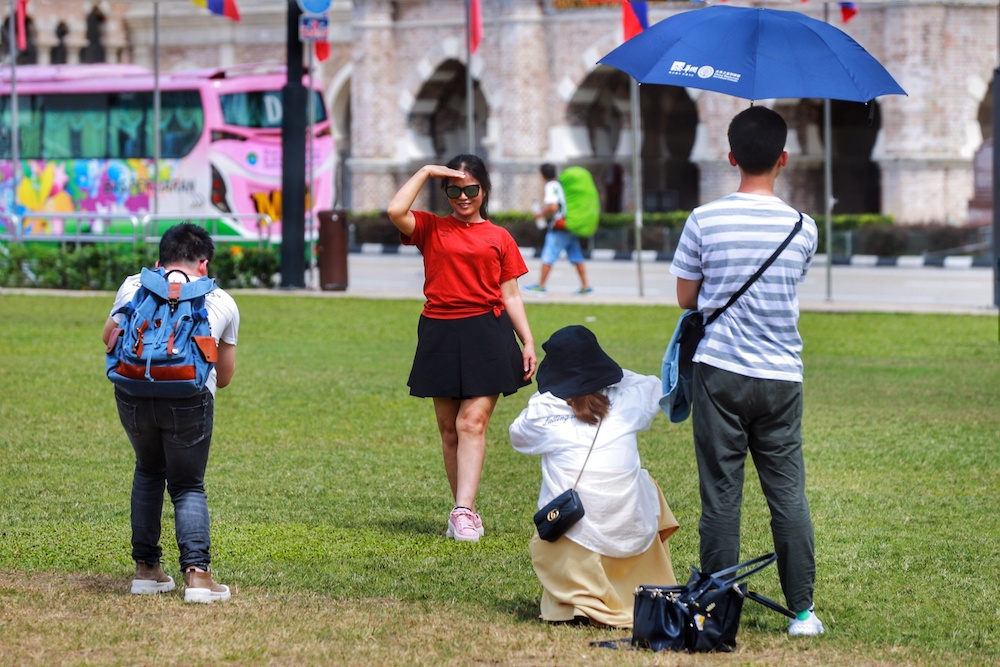 Tourists from China take pictures at Dataran Merdeka in Kuala Lumpur January 23, 2020. u00e2u20acu201d Picture by Ahmad Zamzahuri