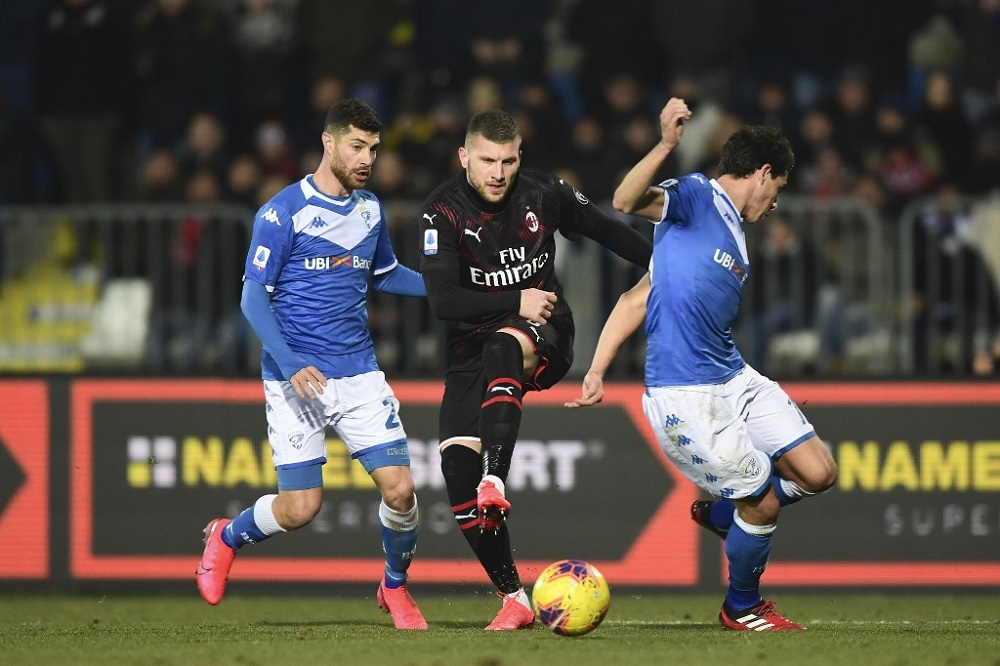 AC Milanu00e2u20acu2122s Croatian forward Ante Rebic (centre) vies with Bresciau00e2u20acu2122s defenders Stefano Sabelli (left) and Andrea Cistana during the Italian Serie A football match at the Mario Rigamonti stadium in Brescia January 24, 2020. u00e2u20acu201d AFP pic