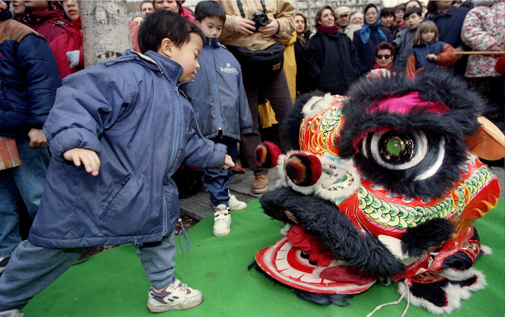 A young boy beats the mask of the head of a carnival dragon during a show in the Chinese district of Paris to celebrate the Chinese New Year, February 18th. u00e2u20acu201d Reuters pic