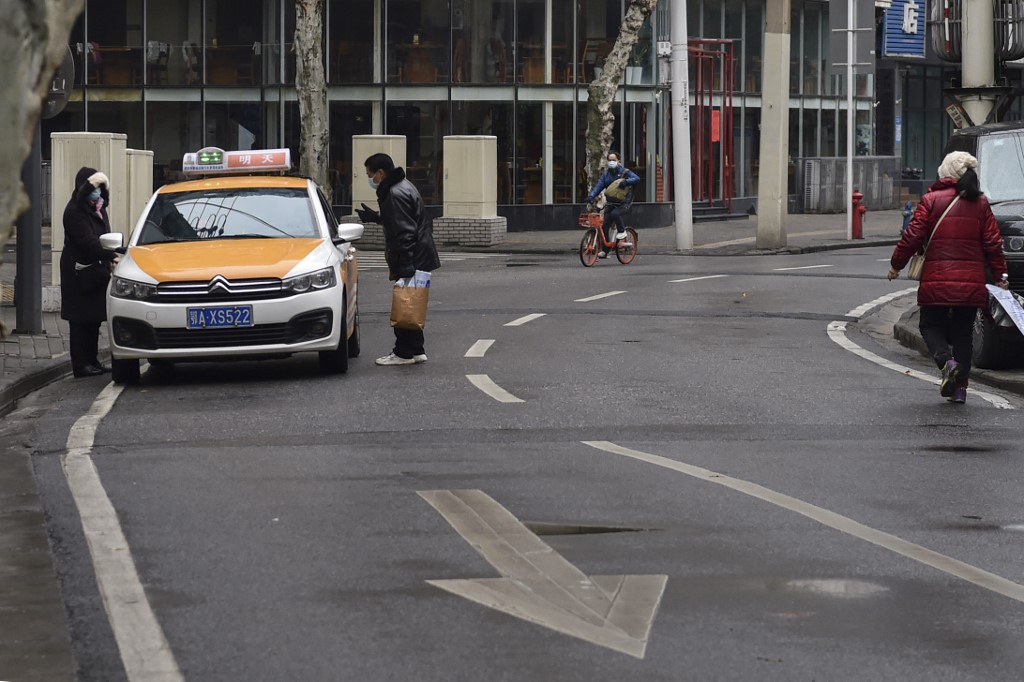 The taxi driver sent warm wishes to Wuhan, despite also catching the virus. — AFP pic