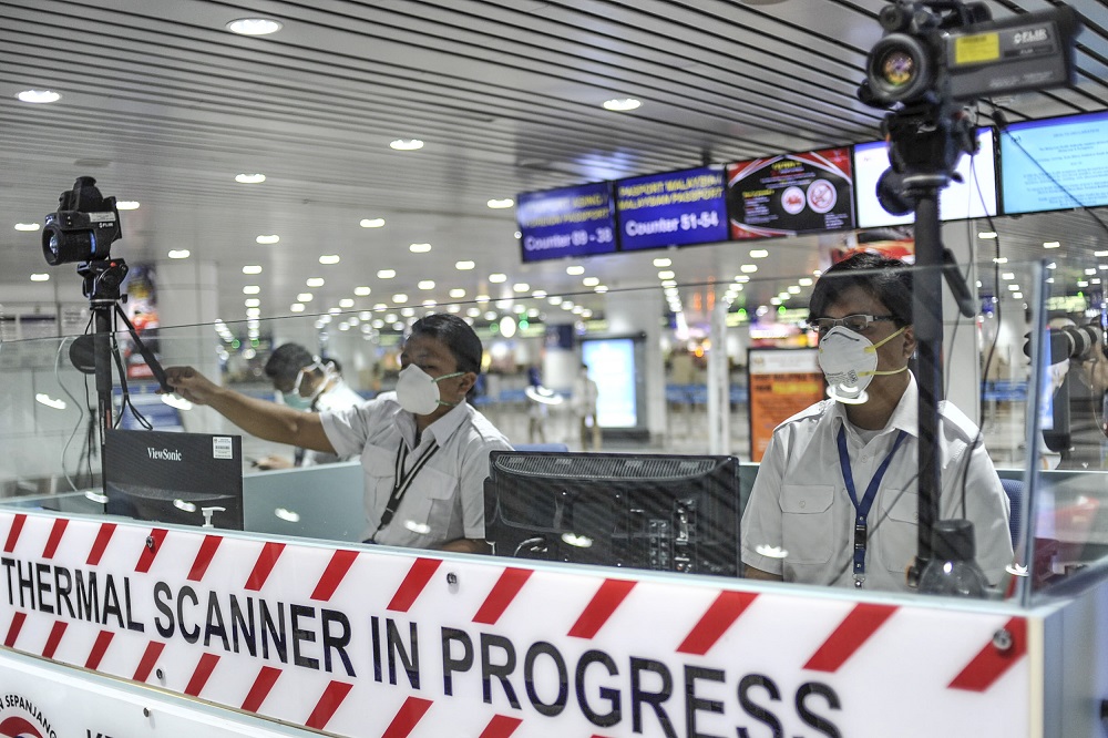 Health quarantine officers stationed at a thermal screening point at the international arrival terminal of the Kuala Lumpur International Airport in Sepang January 27, 2020. u00e2u20acu201d Picture by Shafwan Zaidon