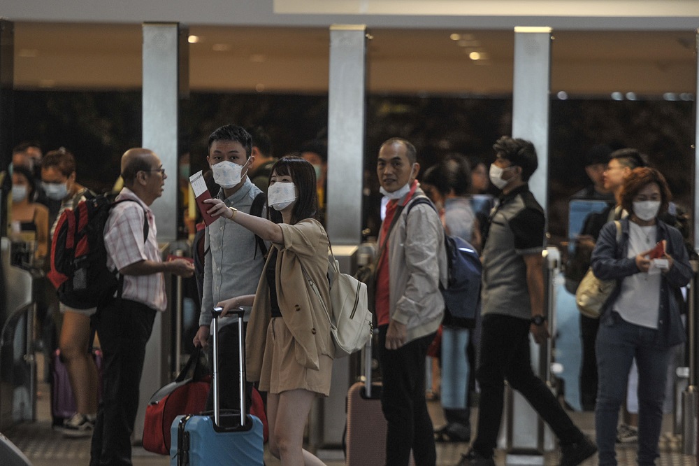 People are seen wearing protective masks at the arrival hall in KLIA 2, Sepang January 27, 2020. u00e2u20acu201d Picture by Shafwan Zaidon