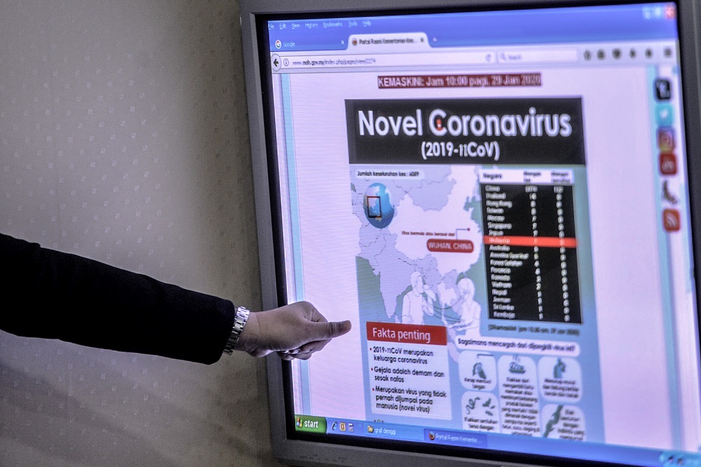 A Health Ministry staff points to one of the monitors at the National Crisis Preparedness & Response Centre (CPRC) in Putrajaya January 29, 2020. u00e2u20acu201d Picture by Shafwan Zaidon