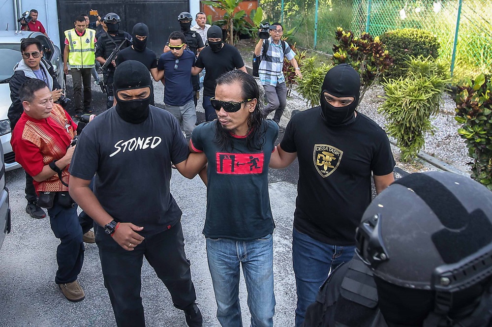 Police personnel lead terror suspects to the Sessions Court in Ipoh January 31, 2020. u00e2u20acu201d Picture by Farhan Najib
