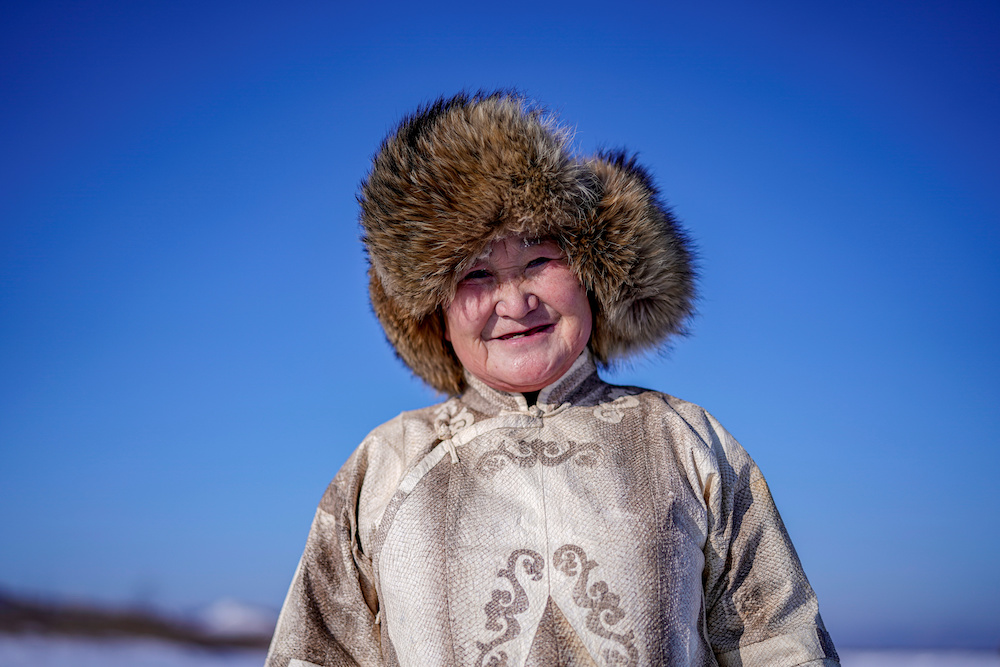 You Wenfeng, 68, an ethnic Hezhen woman, poses with her fishskin clothes at a frozen river in Tongjiang January 1, 2020. — Reuters pic