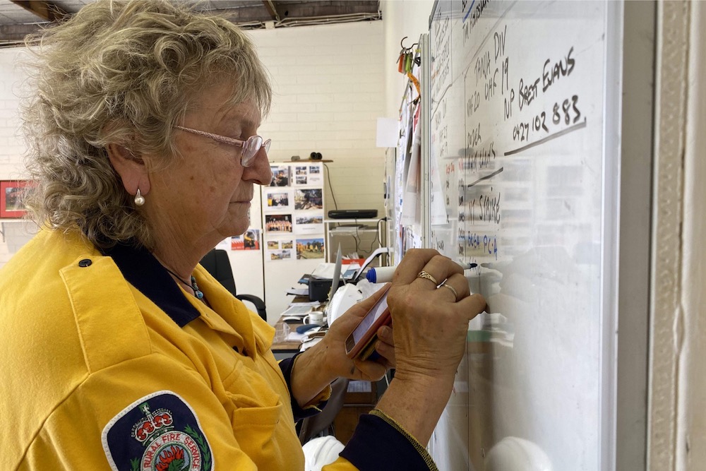 This photo taken on January 19, 2020 shows Bermagui Rural Fire Service president Maggie McKinney writing up the staff roster on a whiteboard at the fire station in the town of Bermagui in New South Wales state. u00e2u20acu201d AFP pic                 