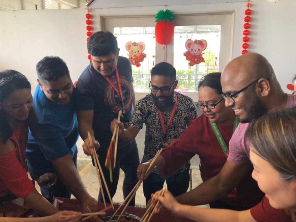 AirAsia Berhad chief executive officer Riad Asmat (in batik) tosses the yee sang with the volunteers of DogQ in conjunction with Chinese New Year. u00e2u20acu201d  Picture courtesy of AirAsia